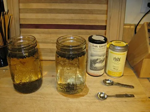Glass jars with water and tea leaves
